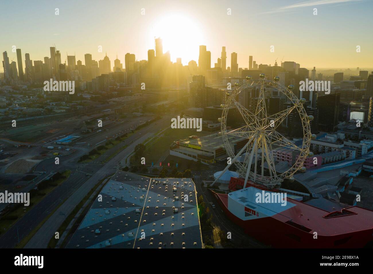 Aerial photo of Ferris wheel and Melbourne CBD at sunrise Stock Photo