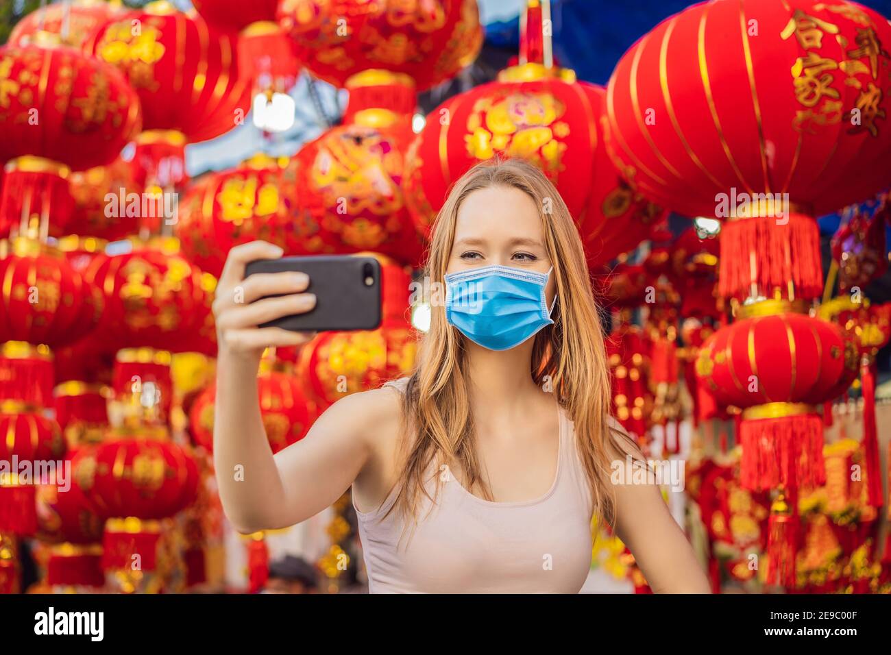 Beautiful Caucasian tourist woman in Tet holidays. Vietnam Chinese Lunar New Year in springtime TEXT TRANSLATION from Vietnamese: Congratulations on Stock Photo
