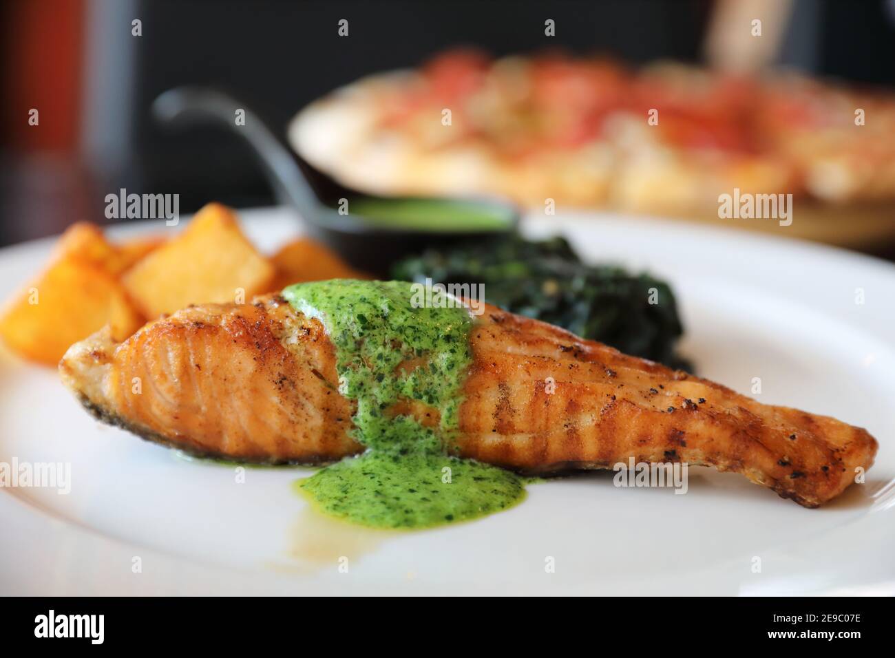 Salmon steak with pesto sauce Stock Photo Alamy