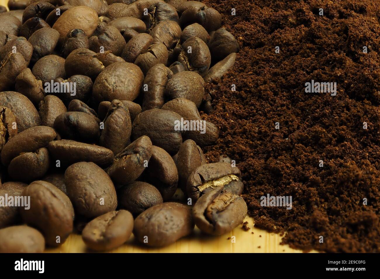 The background of coffee beans and ground coffee. Macro. Brown background. Stock Photo