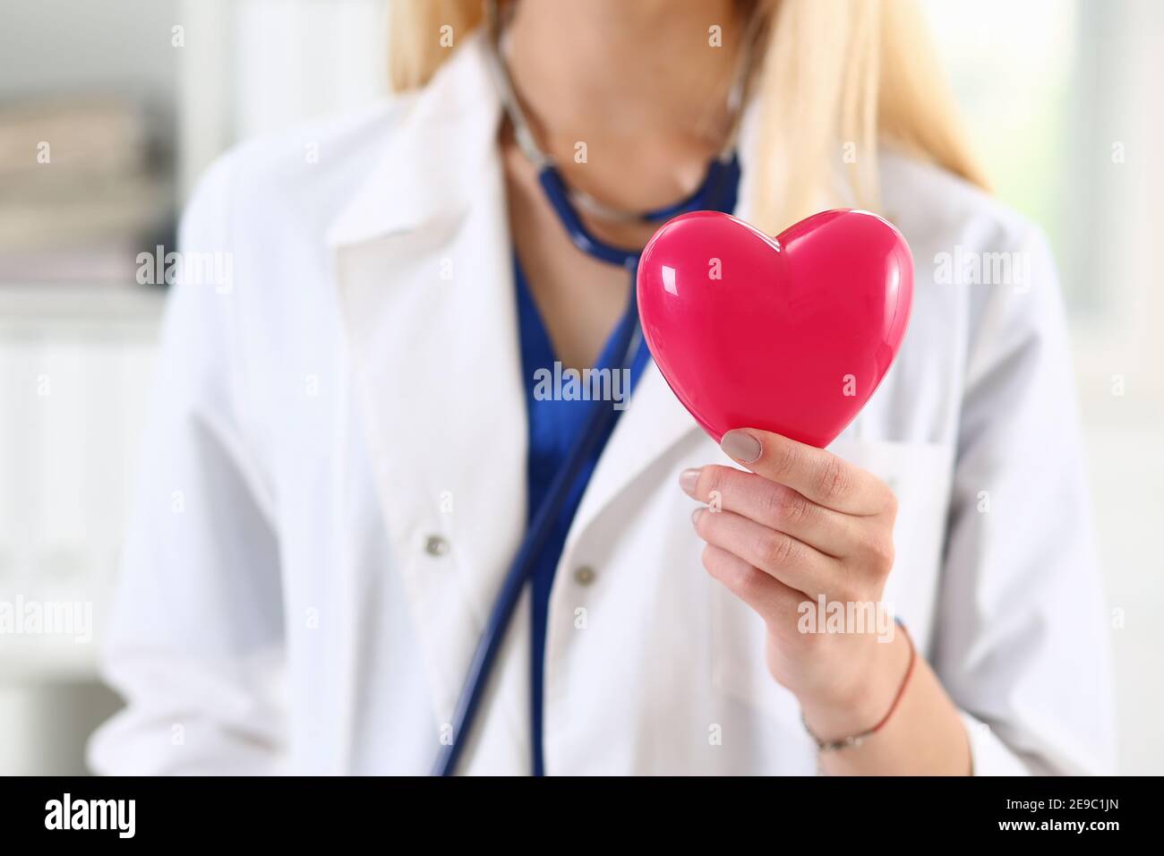 Female medicine doctor hands holding red heart Stock Photo - Alamy