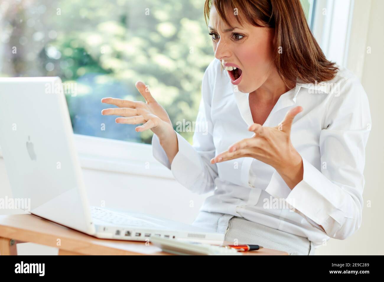 Stressed woman at work Stock Photo