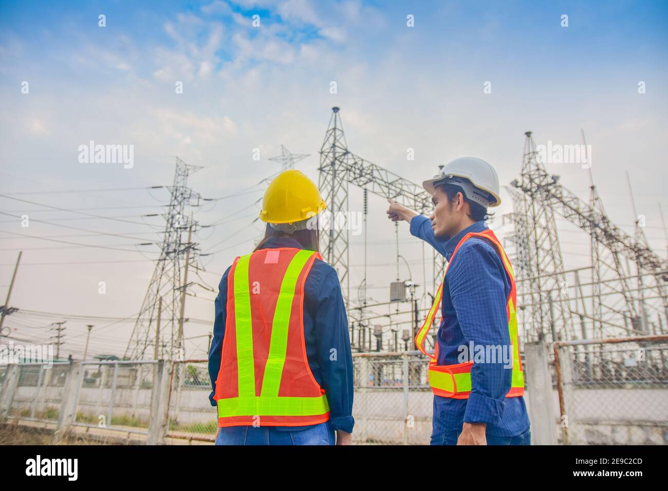 Asian Engineer Man and Women working on site power plant electric system to safety work Stock Photo