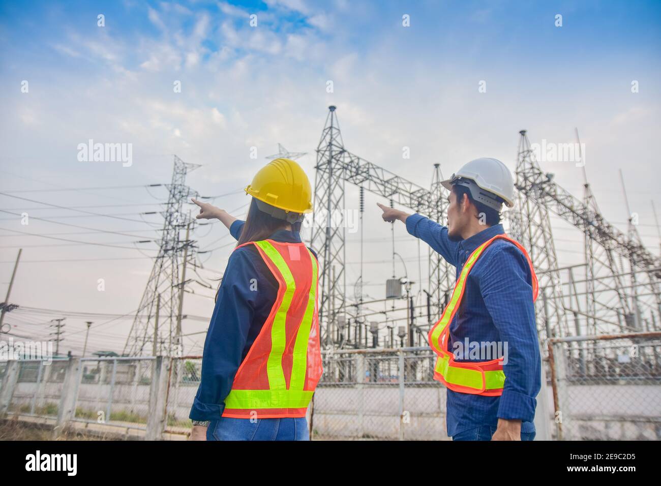 Asian Engineer Man and Women working on site power plant electric system to safety work Stock Photo