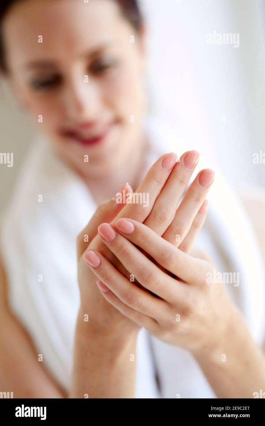 woman looking at her hands Stock Photo