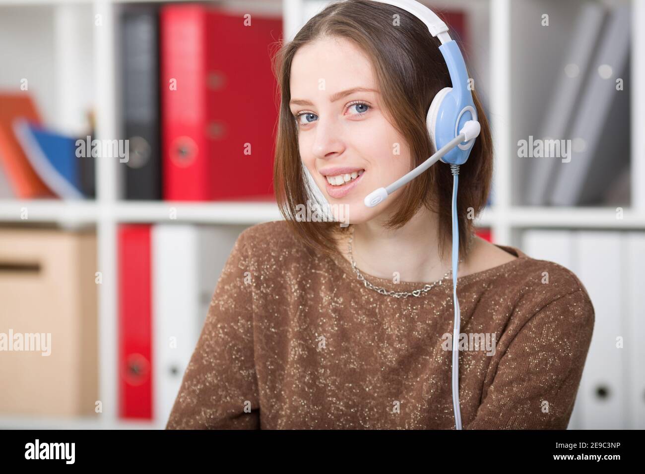 Student woman uses a headset with a microphone for online learning