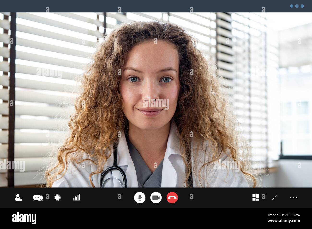 Female doctor looking at the camera while making video call with patient online, home medical consulation service concepts Stock Photo