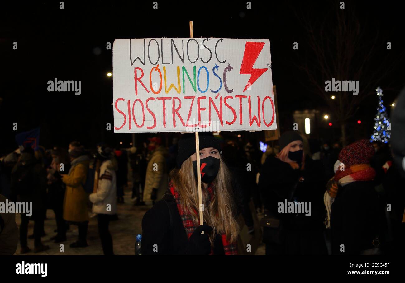 Banner with slogan FREEDOM, EQUALITY, SISTERHOOD and red lightning symbol Women Strike movement in Poland on demonstration in Krakow Stock Photo