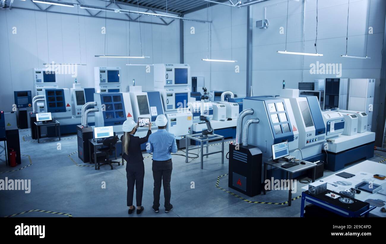 Modern Factory: Two Engineers Use Digital Tablet Computer with ...