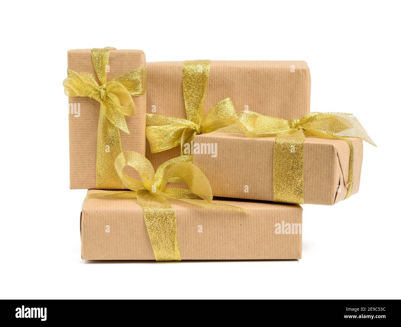 Three gifts in beige wrapping paper tied with brown ribbons on brown Stock  Photo - Alamy