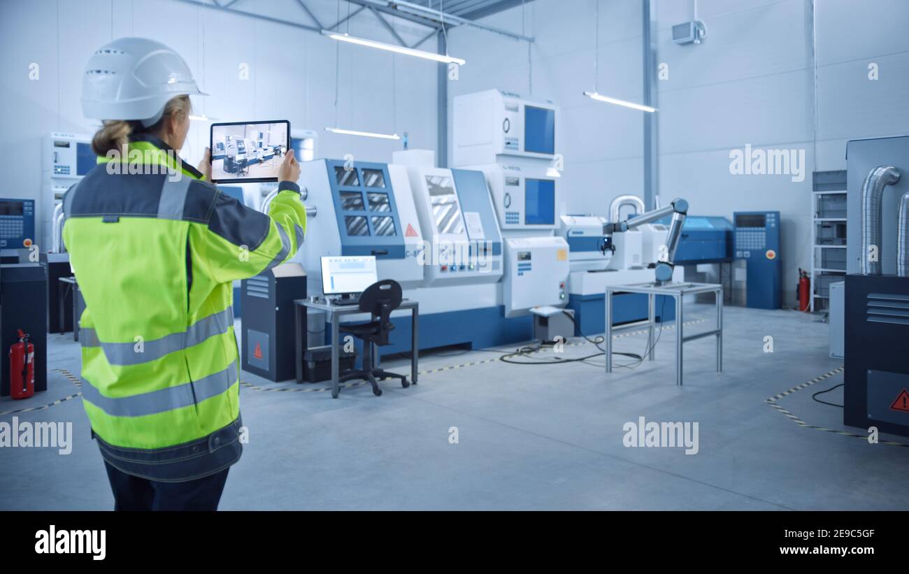 Industry 4.0 Modern Factory: Female Engineer Uses Digital Tablet ...
