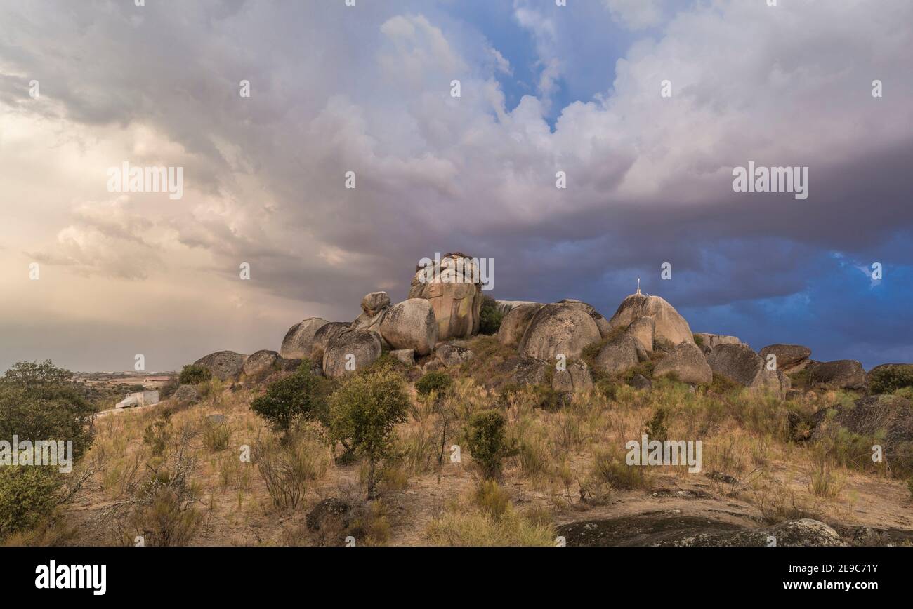 Cloudy sunset over Treasure rocks of Los Barruecos Natural Monument, Caceres, Extremadura, Spain. Stock Photo