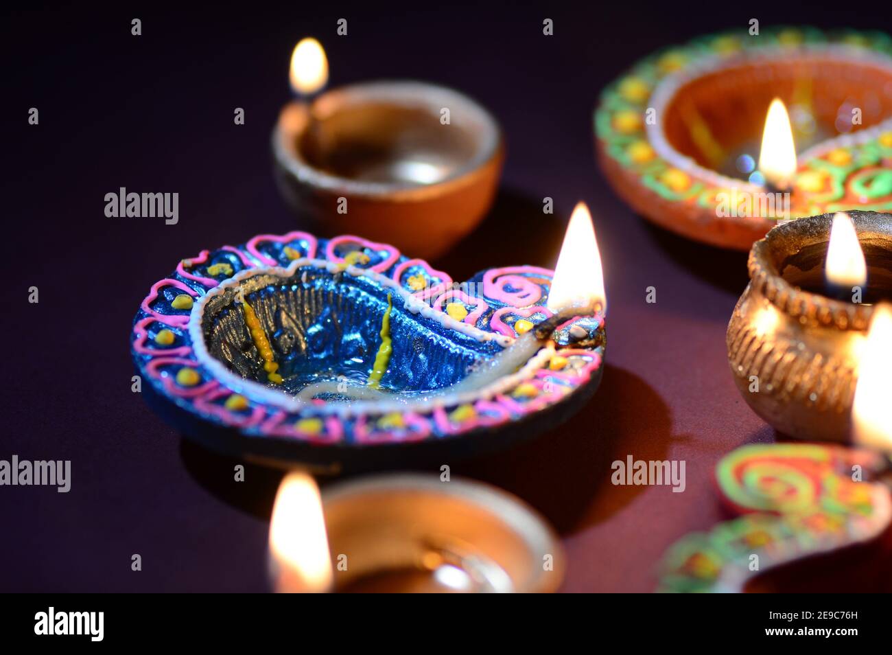 Colorful clay Diya (Lantern) lamps lit during Diwali celebration. Greetings  Card Design Indian Hindu Light Festival called Diwali Stock Photo - Alamy
