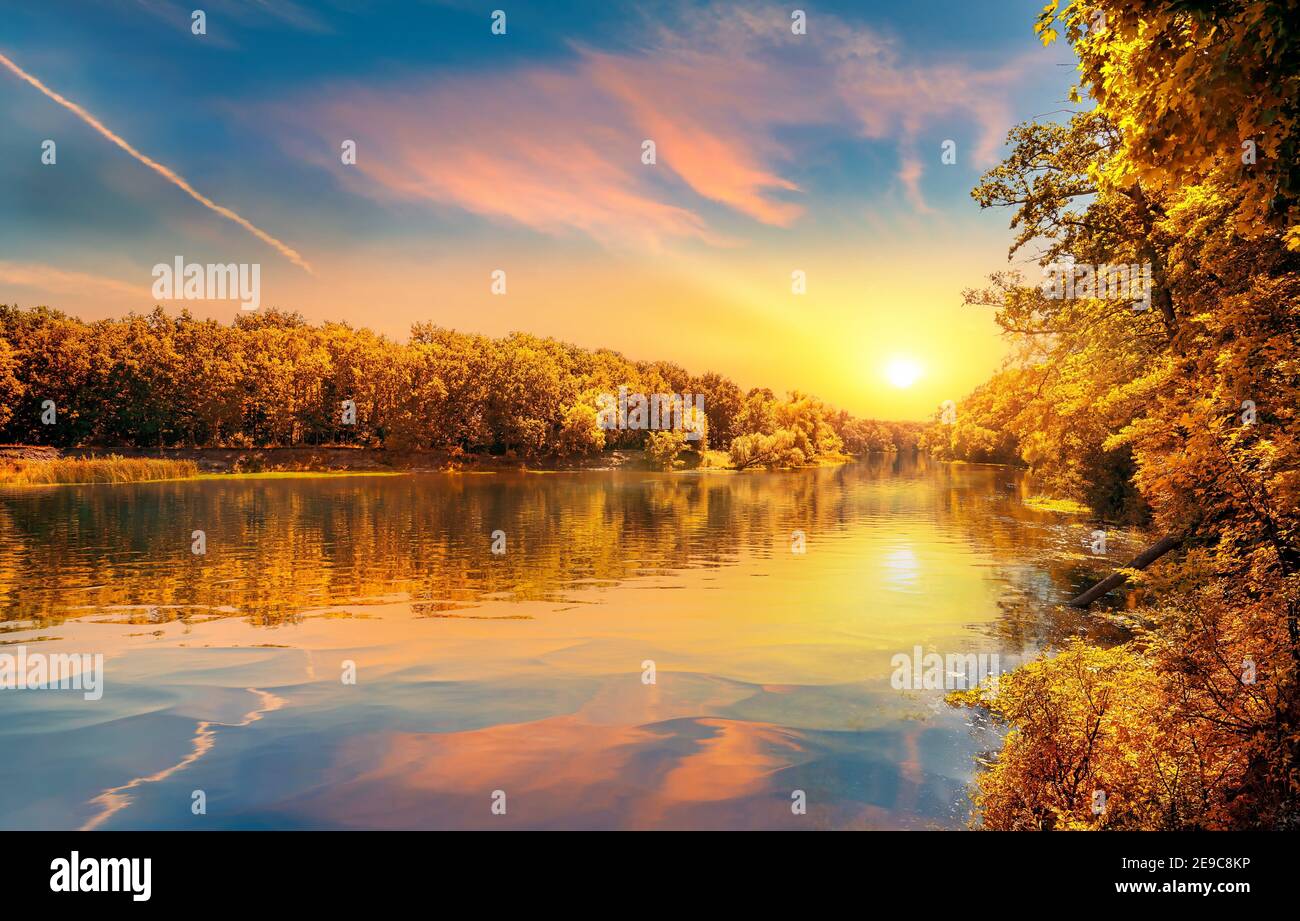 Orange autumn on river in the forest. Stock Photo
