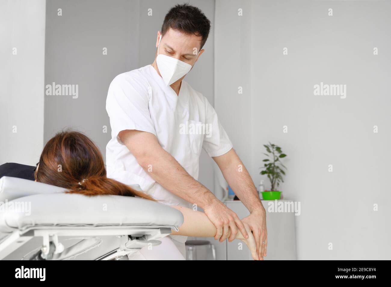 Male therapist giving massage to relief shoulder pain to a female