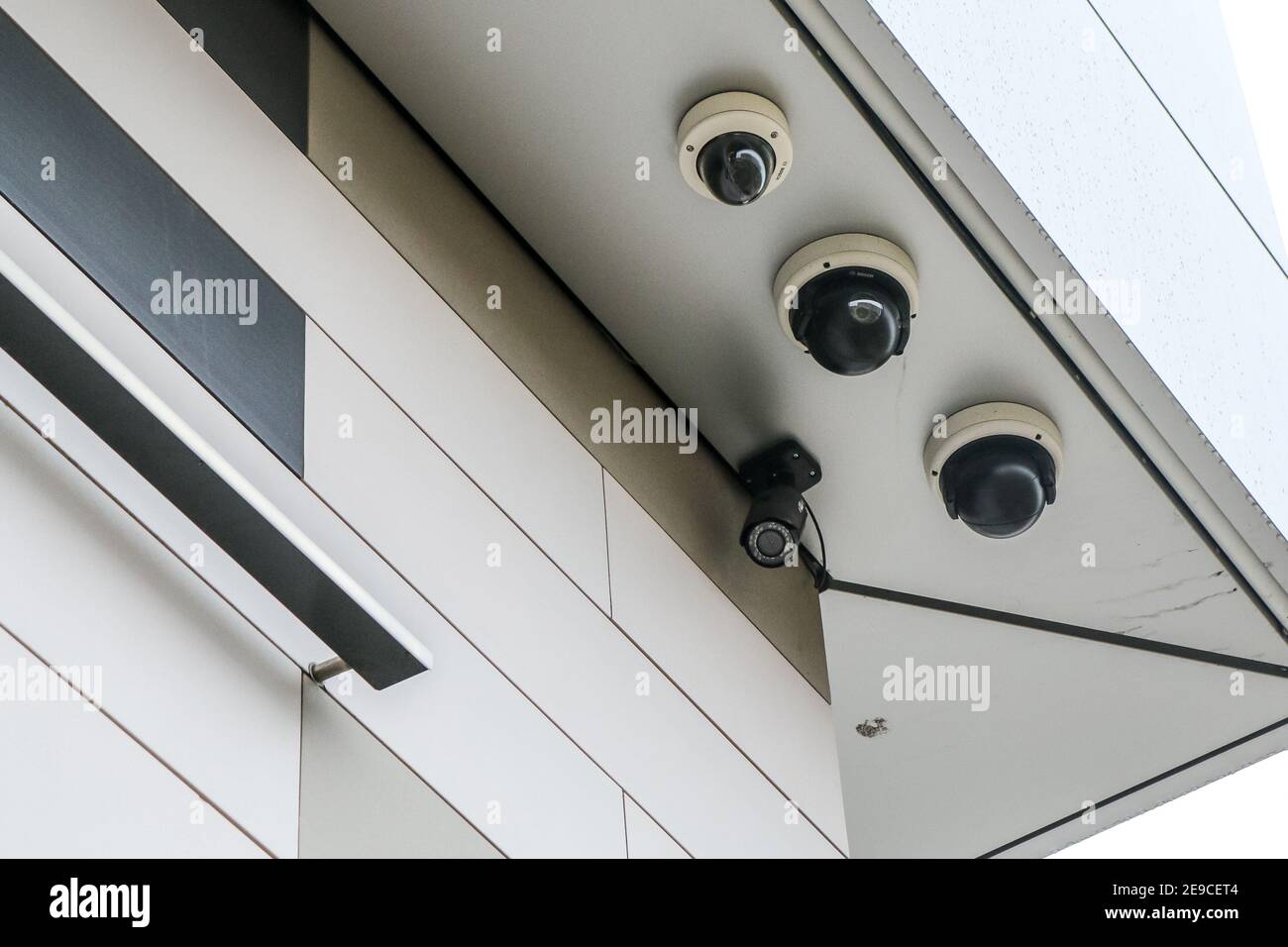 A detail of four cameras on the administrative building. Big brother is watching you. Stock Photo