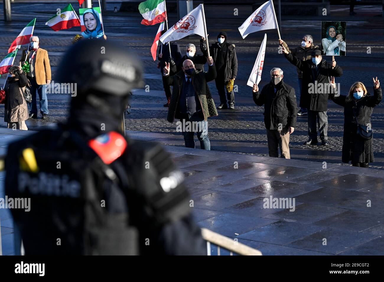 Illustration shows a police officer and a protest action outside the justice palace during a session of the trial of four persons, including a Belgian Stock Photo