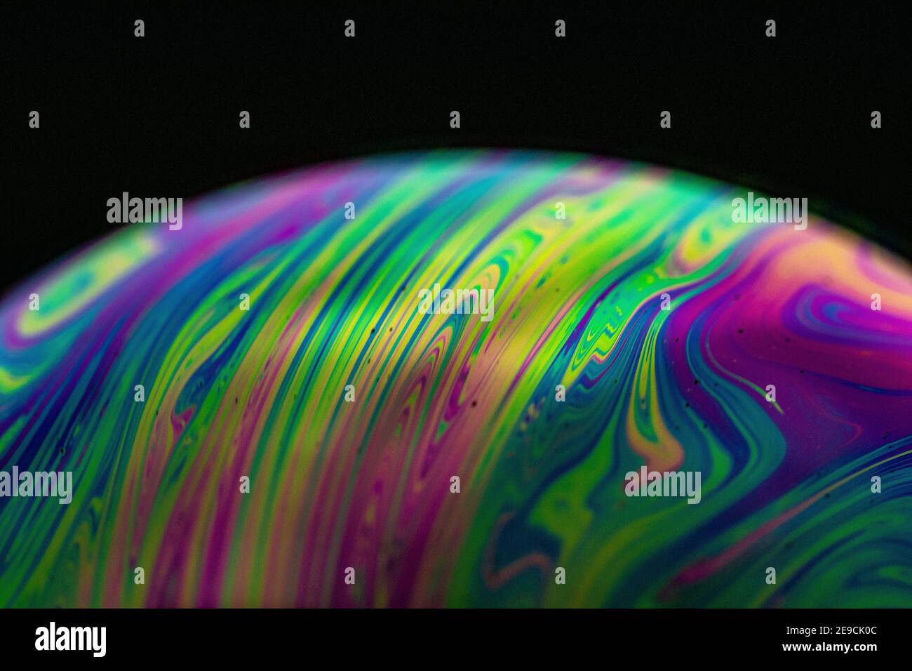 Closeup of a sphere with beautiful vibrant colors on dark background ...
