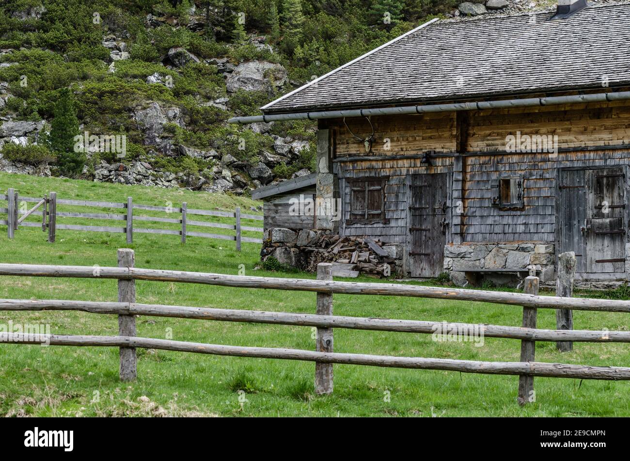 house of wood in the mountains with fence Stock Photo