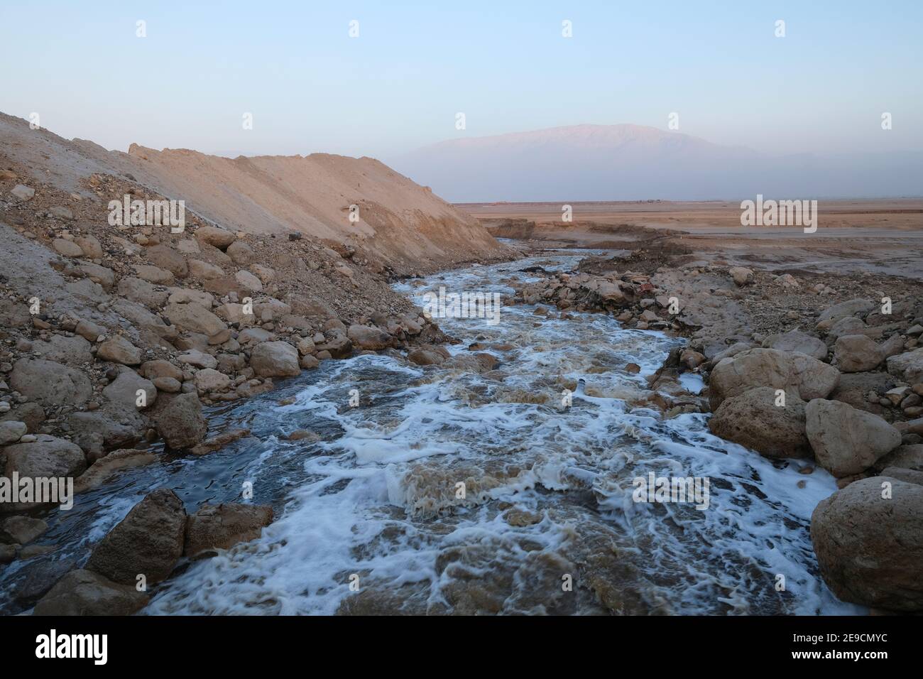 View from the salt wall barrier along the border with Jordan on September 13, 2022, in the Dead Sea, Israel. Israeli army is erecting a unique project of a natural salt barrier south of the Israeli settlement of Neot HaKikar in the southern Dead Sea area, The salt wall extracted from the Dead Sea will reach a maximum height of 13 meters (42 ft) for 40 km (24 miles) and will make it difficult for infiltrators to cross the border from Jordan. Stock Photo