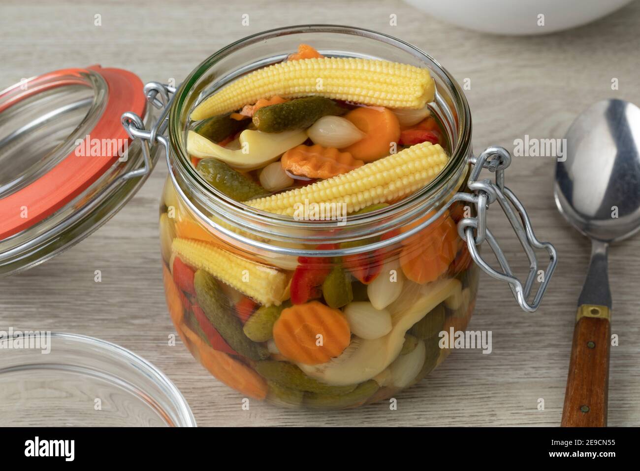 Glass jar with homemade pickled vegetable mix close up as a side dish Stock Photo