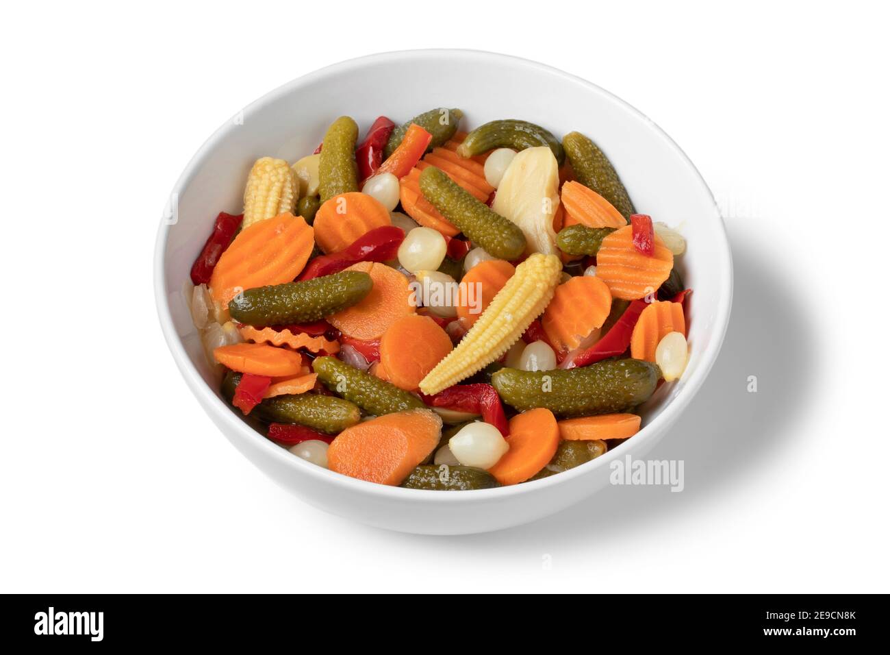 White bowl with colorful homemade pickled vegetable mix close up as a side dish isolated on white background Stock Photo