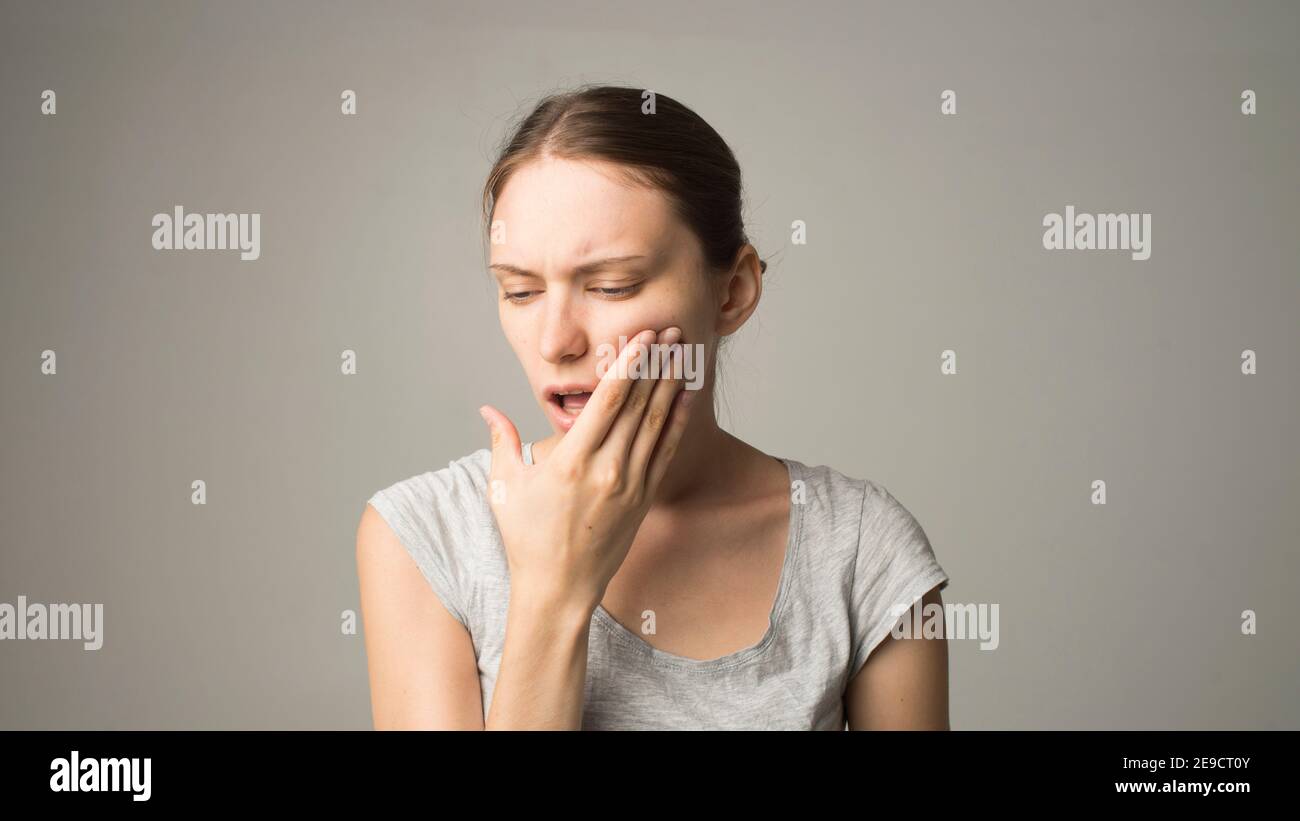 A woman with a pain in her teeth clutches her face Dentist medicine Stock Photo Alamy