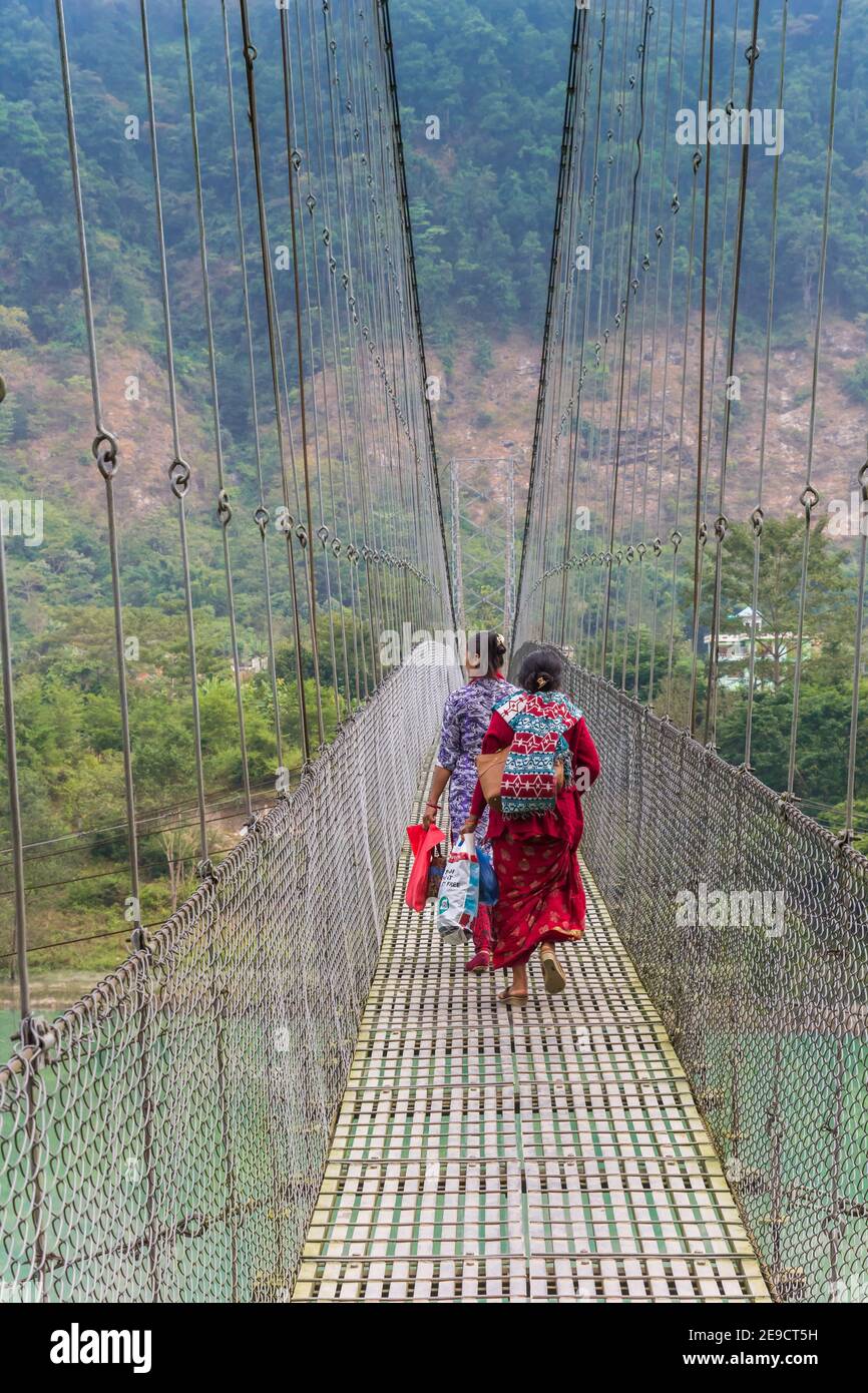 Women crossing the suspension bridge over the Trishuli river in Nepal Stock Photo Alamy