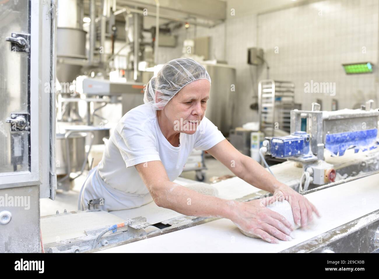 Worker in a large bakery industrial production of bakery products on