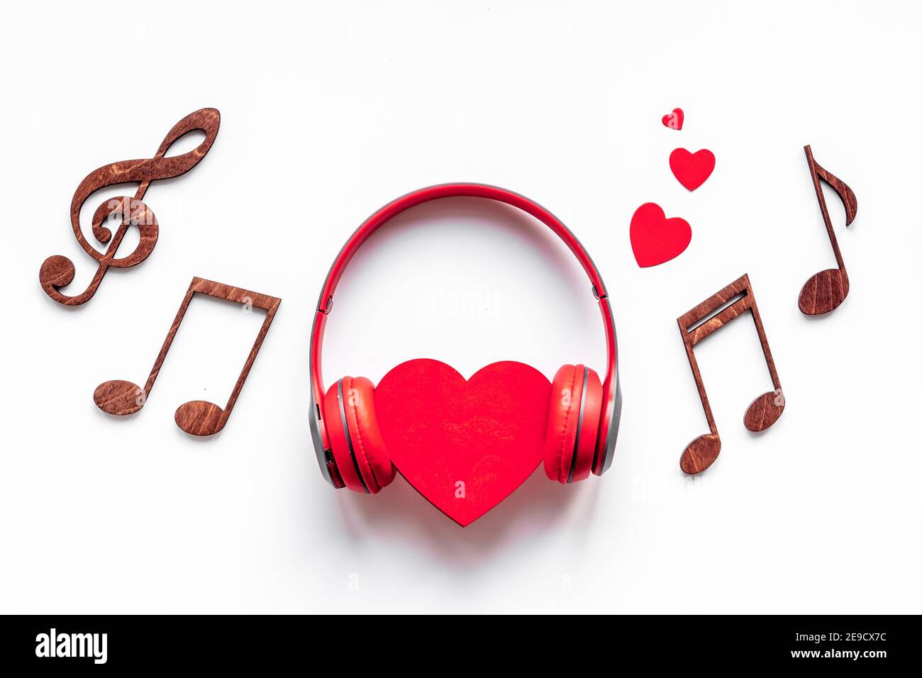 Red headphones with heart shape. Listen to the music concept Stock