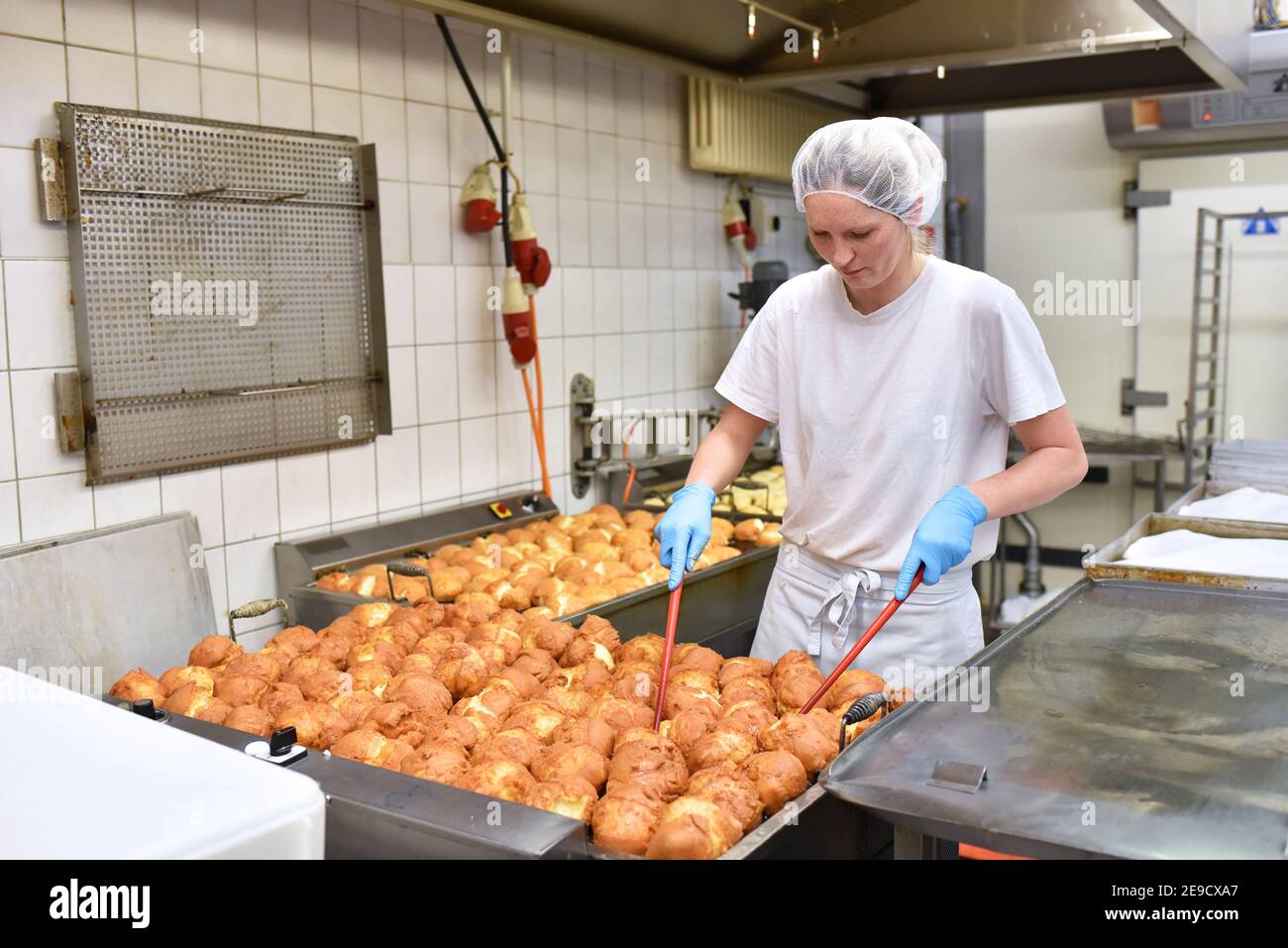 Worker in a large bakery industrial production of bakery products on