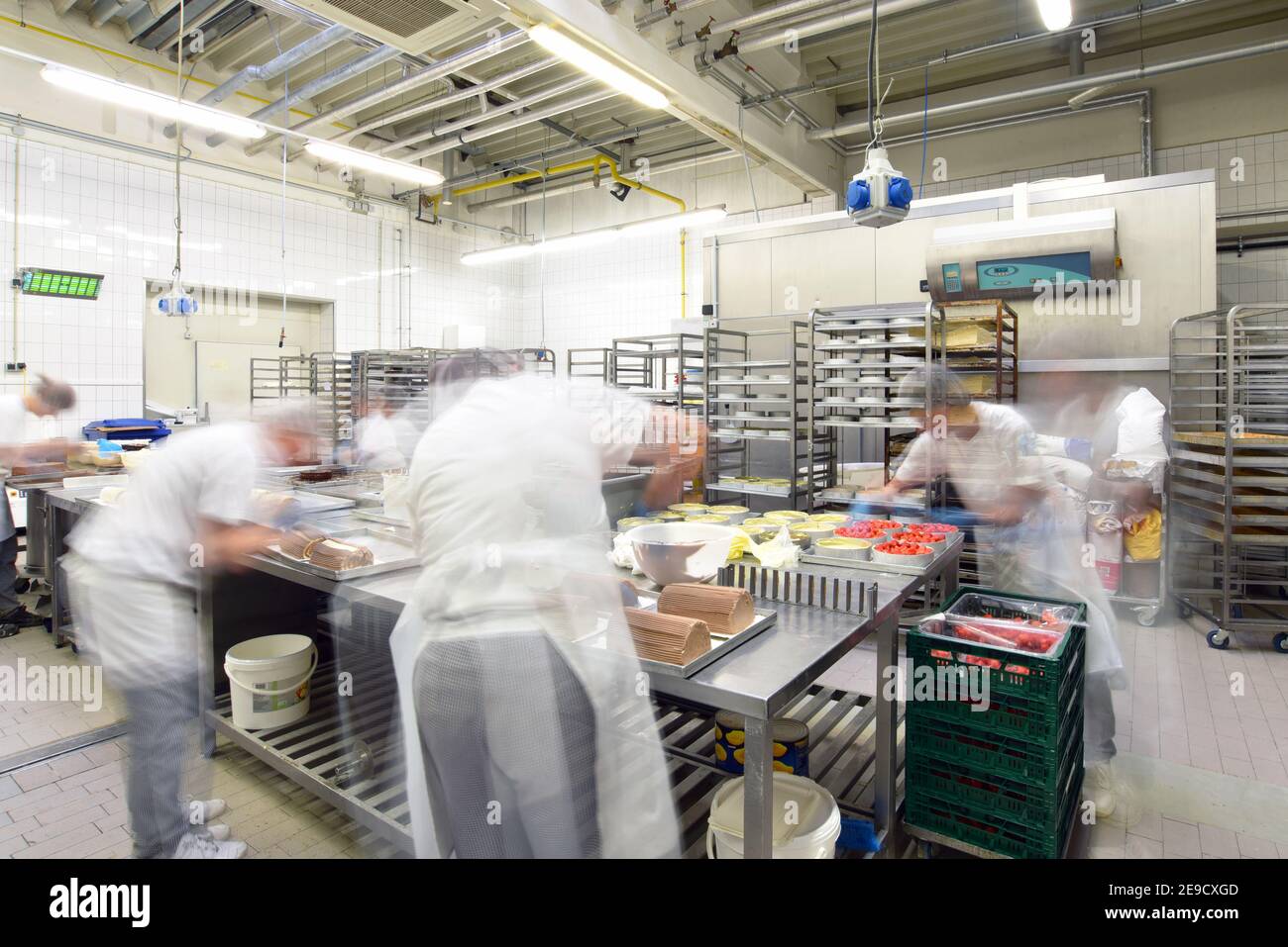 Worker in a large bakery - industrial production of bakery products on an assembly line Stock Photo