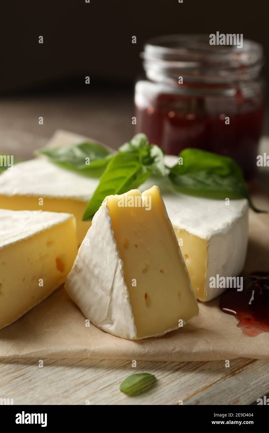 Concept of tasty eating with camembert and jam on cutting board Stock Photo