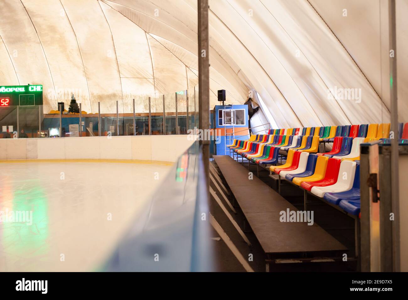 Ice rink multicolored grandstand seats. The indoor rink is allseason
