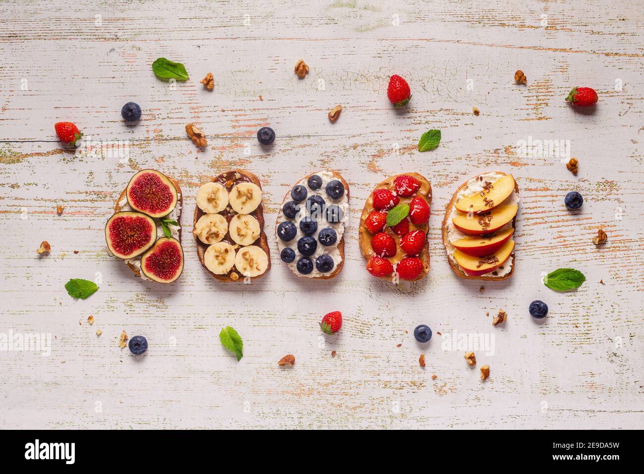 Homemade summer toast with cream cheese, nut butter and fruits and