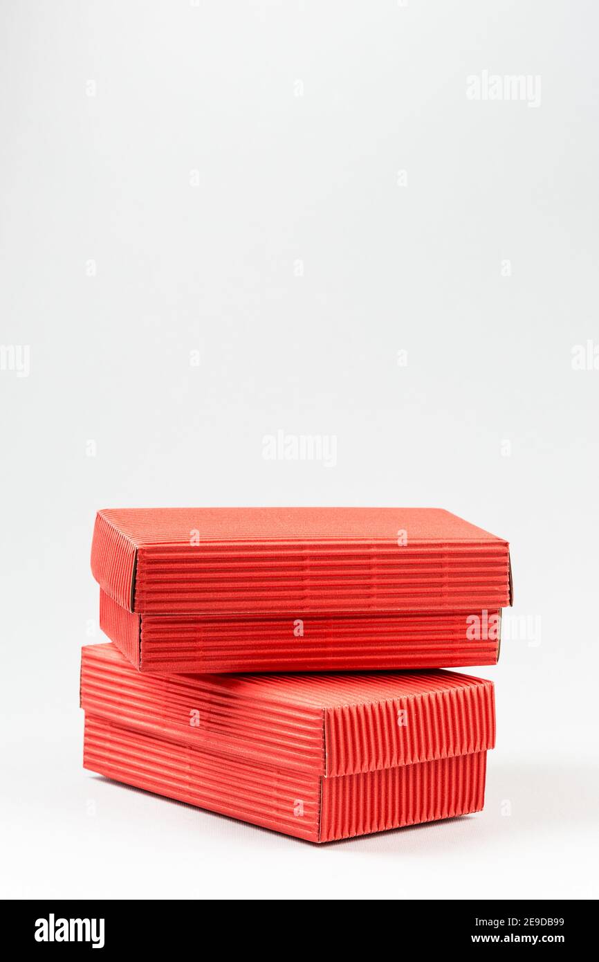 Two red closed corrugated cardboard boxes on white. Valentine's Day gift box packaging concept Stock Photo