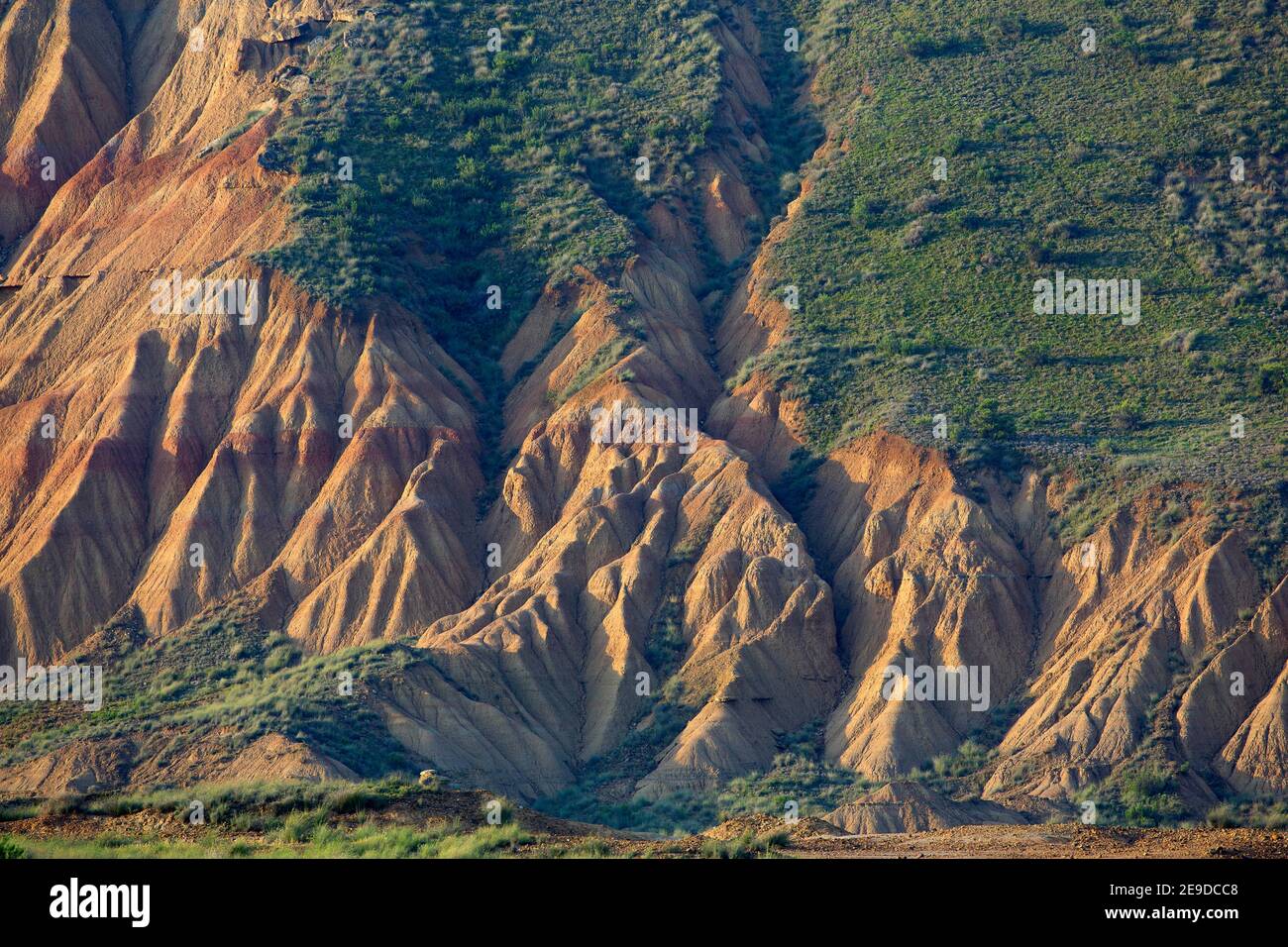mountain slope of semi-desert Bardenas Reales at sunrise, Spain ...