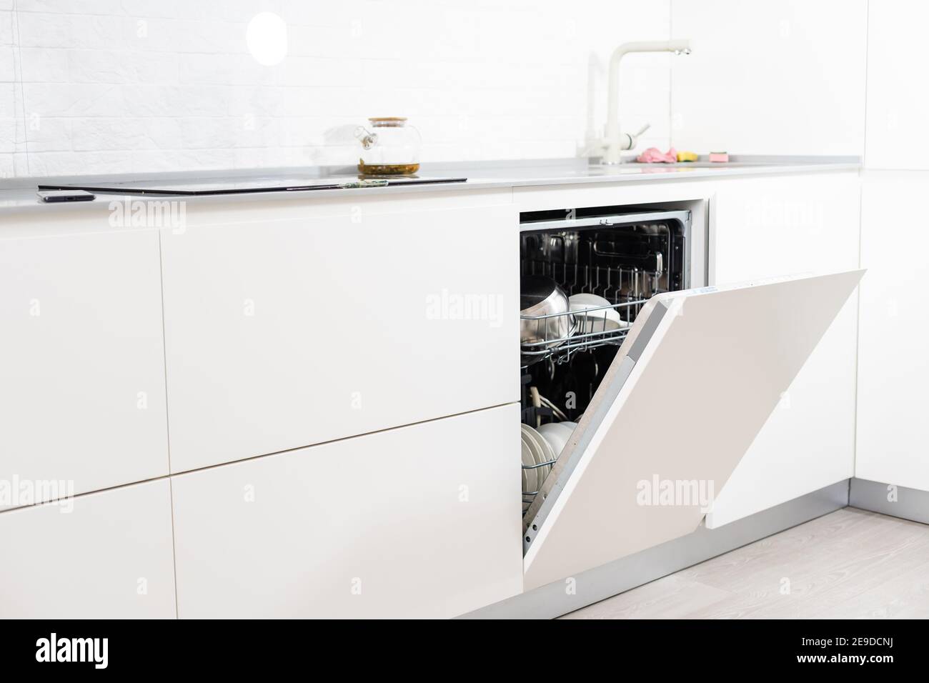 Open dishwasher with clean utensils in it Stock Photo Alamy