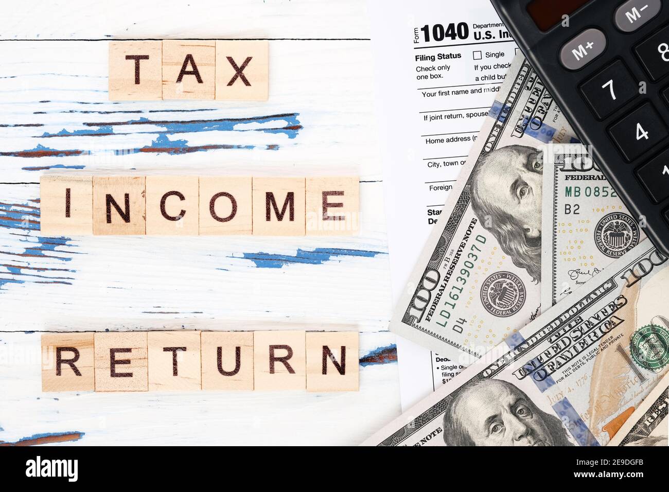 Personal tax form 1040, dollar bills and calculator Stock Photo