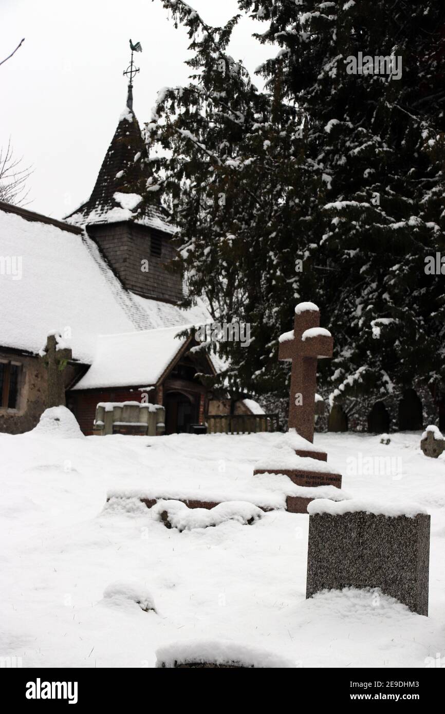 Church and churchyard of St Nicholas, Pyrford, Surrey, in snow in ...