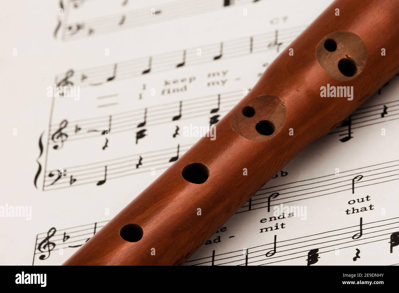 A wooden recorder, wind instrument, with sheet music. Resting during a  break in the music Stock Photo - Alamy