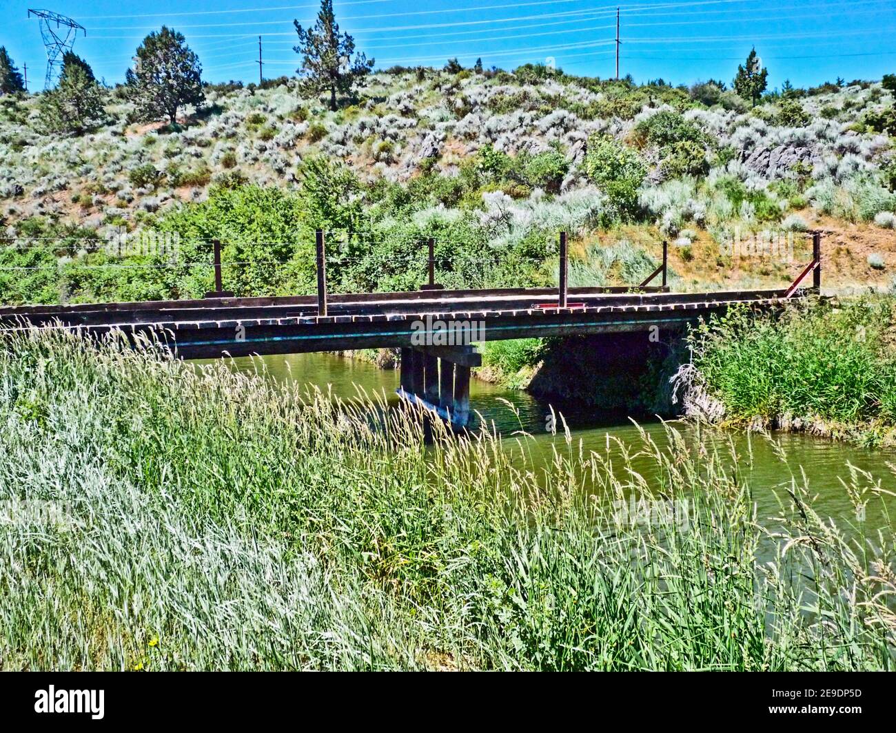 Wooden bridge across the Keno Canal which runs adjacent to the Link River in Klamath Falls, Oregon, U. S. A. Stock Photo