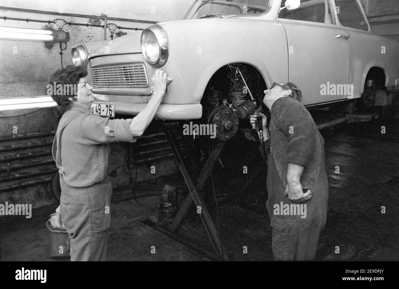 30 November 1984, Saxony, Delitzsch: A Trabant 601 car is being spruced  up in the mid-1980s in a small maintenance shop, with paint polish and  underbody protection. Exact date of recording not
