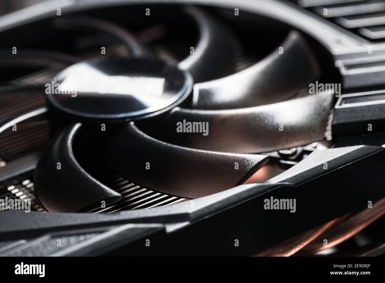 New shiny black plastic GPU cooler, close-up photo with selective focus. This fan is mounted on a video card to cool the GPU Stock Photo