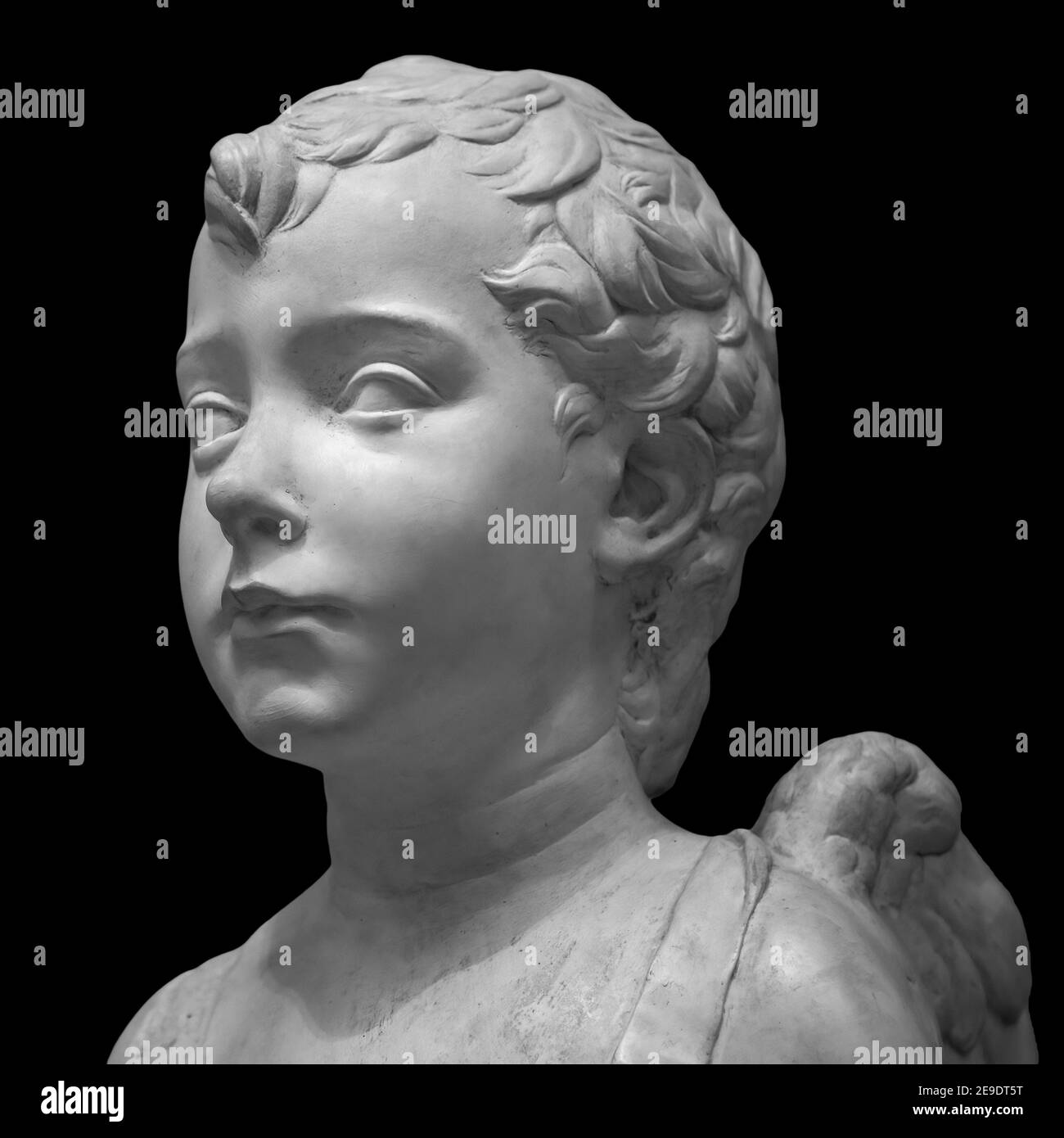 Ancient roman marble portrait of a boy. Young man head statue isolated on black background. Antique sculpture Stock Photo