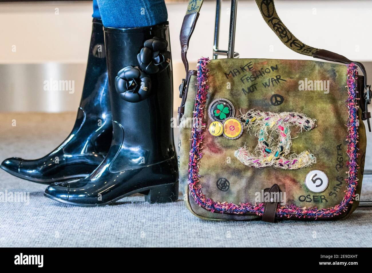 London, UK. 4 Feb 2021. Designer Wellington Boots by Chanel with Camellia  design (part of a set of 2 pairs) est £200-300 with a Graffiti On The  Pavements Messenger Bag, Spring 2015,