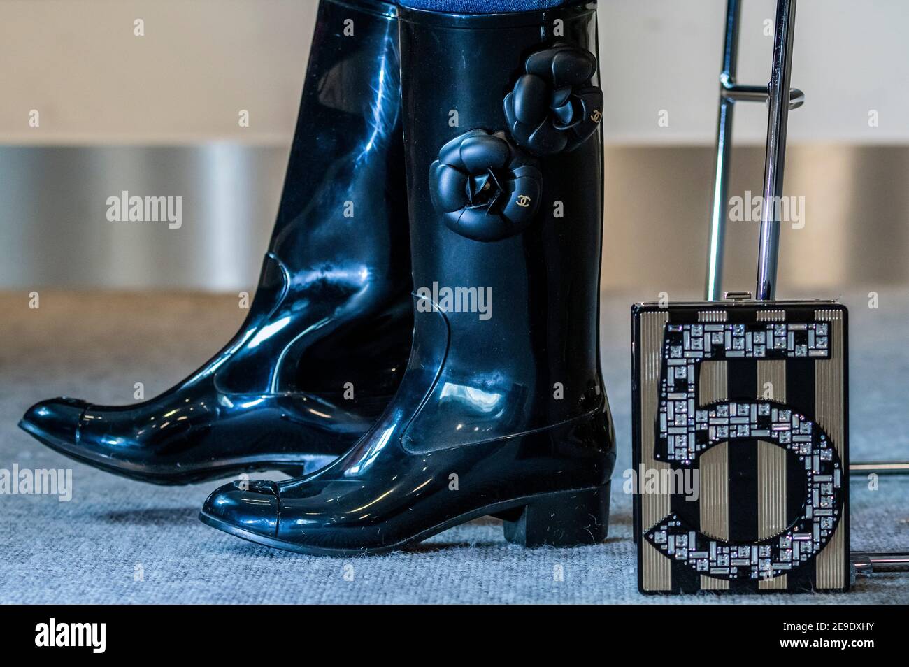 London, UK. 4th Feb, 2021. Designer Wellington Boots by Chanel with  Camellia design (part of a set of 2 pairs) est £200-300 with a Black and  Gold No.5 Plexiglass Miniaudiere, Chanel, Limited