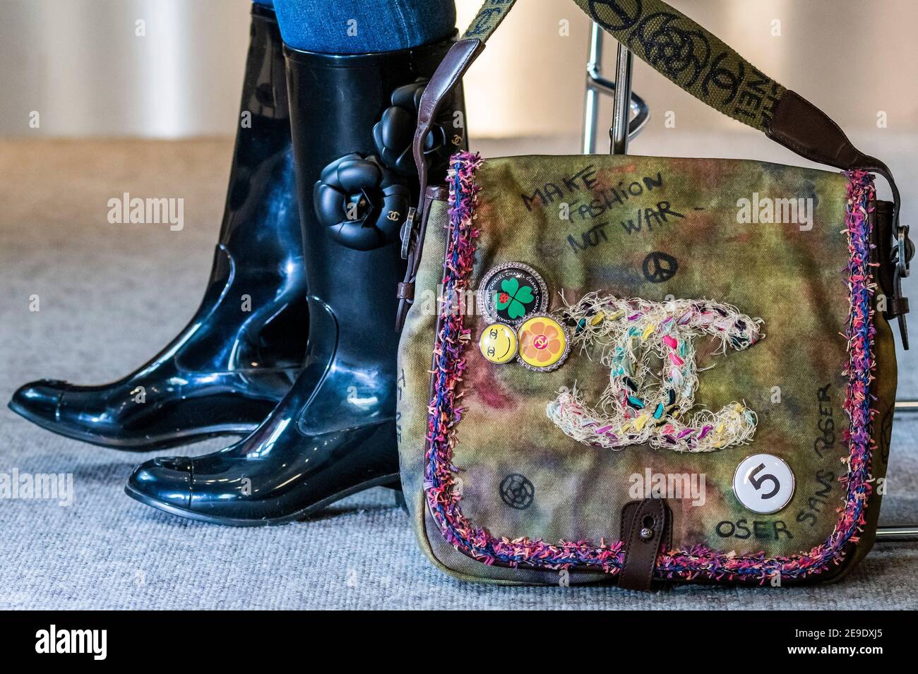 London, UK. 4 Feb 2021. Designer Wellington Boots by Chanel with Camellia  design (part of a set of 2 pairs) est £200-300 with a Graffiti On The  Pavements Messenger Bag, Spring 2015,