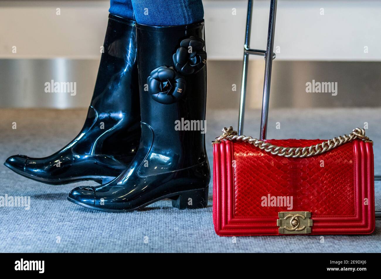 London, UK. 4th Feb, 2021. Designer Wellington Boots by Chanel with  Camellia design (part of a set of 2 pairs) est £200-300 with a Red Python  Medium Boy Bag, Chanel, c. 2014,