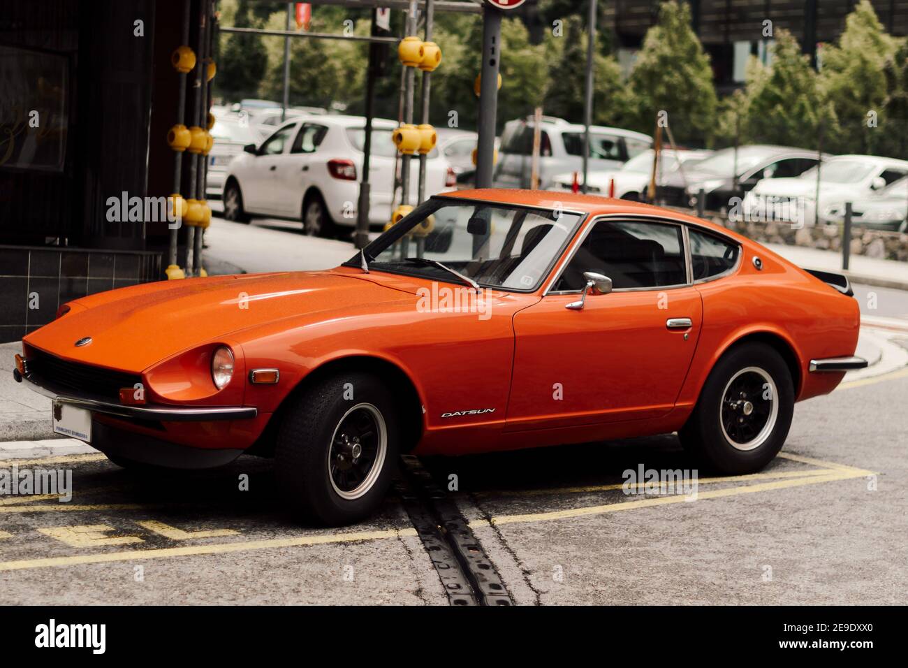 ANDORRA, ANDORRA - Aug 08, 2015: Selective Focus - side view of the classic car Datsun 240Z by Nissan, parked in Andorra in a rainy day. Classic sport Stock Photo